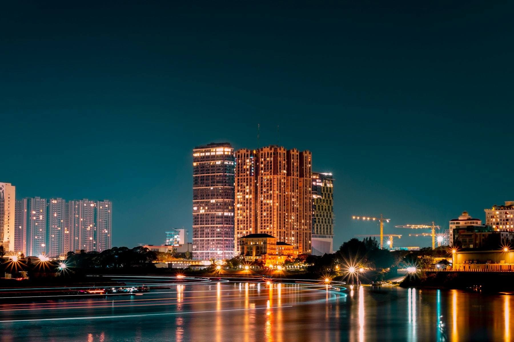 Phnom Penh's riverfront towers at night, lights on the water
